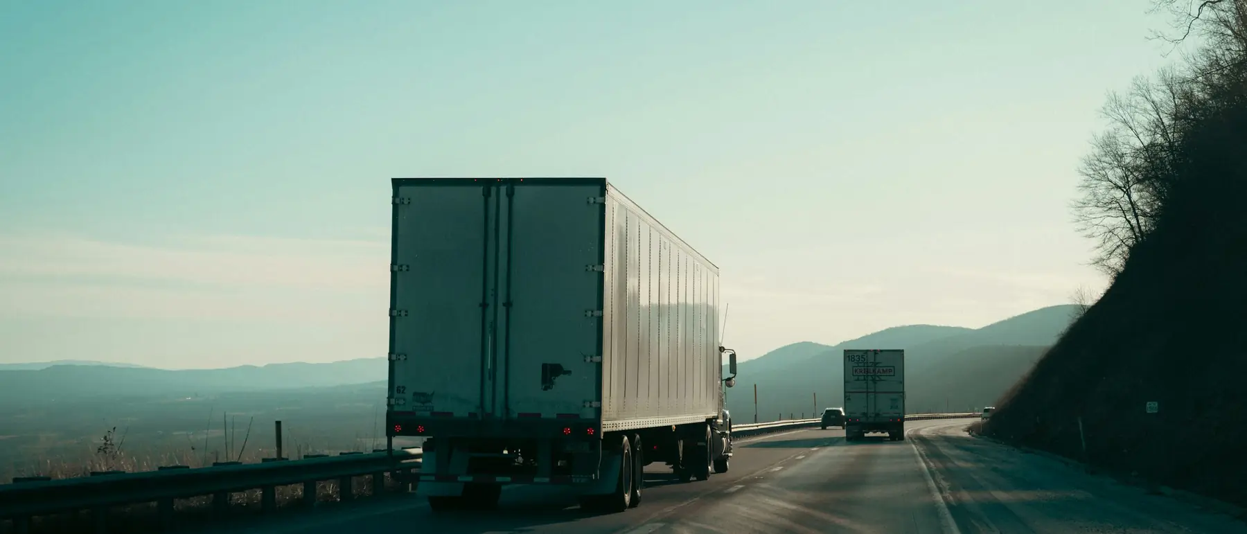 Dry van trailer travelling on a highway at first light